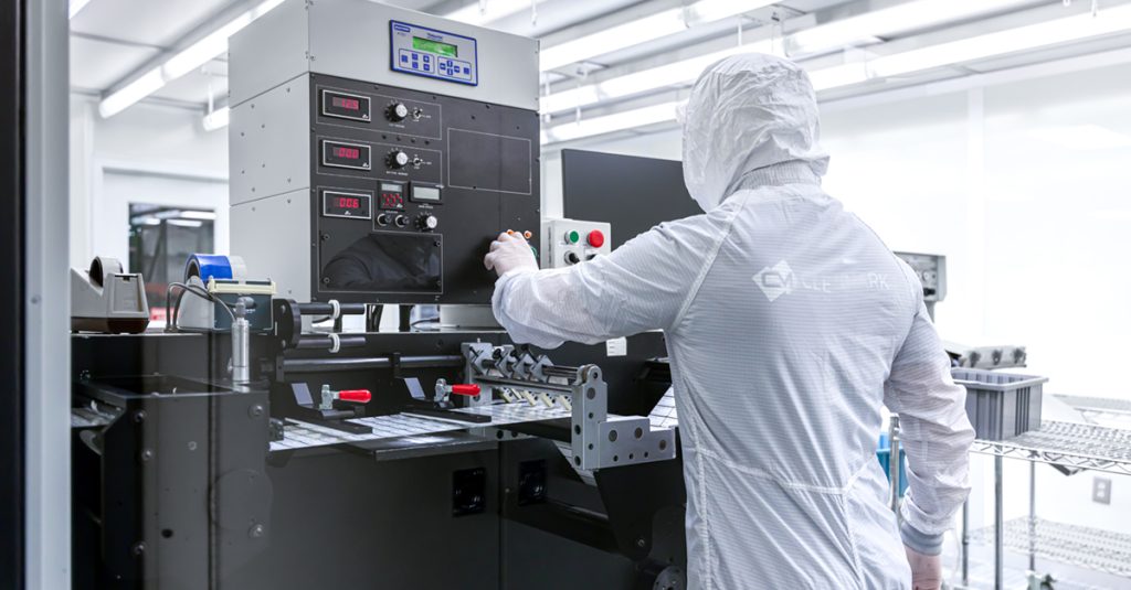 A technician making IPA cleaning resistant labels